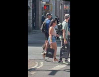 Guy ride board with dog cross street