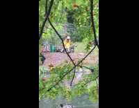 person in park with giant kid costume in yellow shirt