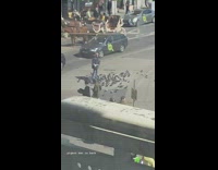 Man feeds the pigeons on the sidewalk