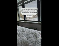 Black and white dog looks over when girl sneezes.