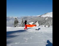 Man jumps for video at snowy mountain