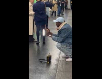 Woman kneels with water bottle on head