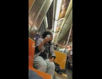 Collab Subway Creatures - Woman dances with phone in her hand while listening to music on subway train 