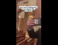 Dad watches sports at wedding