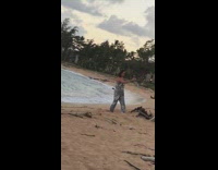 Grey jumpsuit girl beach selfie bonfire sticks 