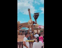 People hanging upside down on a stopped roller coaster