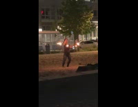 Woman dances with two sticks on fire 