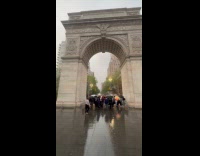 Crowd taking cover underneath washington square arch