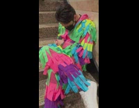 Man dressed as pinata asleep on stairs