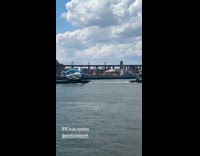 Woman shows pigeon float down the river