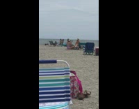 Purple bikini lady holds light reflector beach 