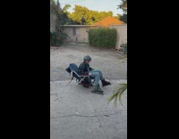 Kid skate around with lawn chair over onewheel