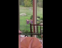 Bridesmaids in purple dresses run across grass gold course to reception at wedding