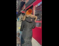 Drag queen blond wig blue shorts struts into bar and sings Wrecking Ball