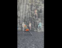 Group of model stands and sits on the rock