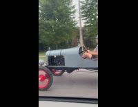 Man drives vintage car on the road