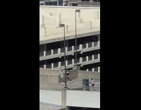 Two men leprechaun kick rooftop parking lot