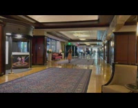 Woman jumps in pink dress at resort 