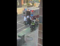 Man photographs paramedics try to load patient