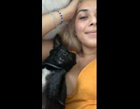 Dog sleeping lays down comfortably at woman 