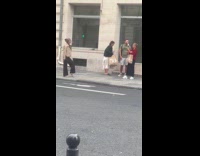 Woman brown jacket poses for sidewalk photo