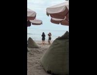 Woman bikini top dances at the beach