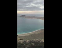 Car drives mountain blue ocean water sunset