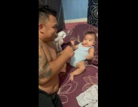 Man Clenches Fist and so Does Baby