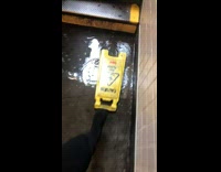 Pedestrians use yellow wet floor sign as a step at the bottom of flooded stairwell