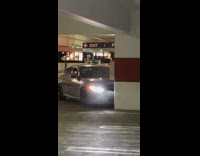 Blue BMW runs into parking structure pillar 