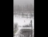 Red jacket person skis across park snow 