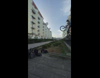 Man on Bike Jumps Toward Walkway but Slips off