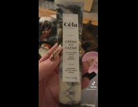 Girl laughing at creme de la creme lotion bottle makeup