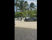 Guy suit sit black Lamborghini car hood