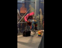 Collab WINY - Man exercises behind the woman at sidewalk