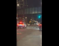 Traffic light swings low at the street