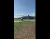 Two men tiktok dance while woman in stilt takes video