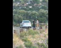 Three women tiktok dance beside the car