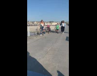 Woman ripped jeans dance tiktok pier bike