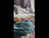 Girl sleeping same way as cat in bed 