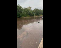 Car and truck on highway submerged in flood 