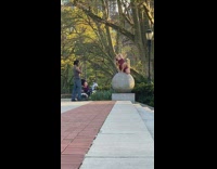 Red romper girl cement sphere ball