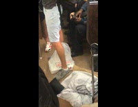 Guy leaves dozen box of krispy kreme donuts on the ground on subway train