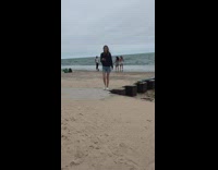 Two women in bikini top tiktok dance at the beach