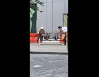 White hat lady sits black bench barricades