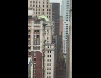 Guy swings from rope from rooftop
