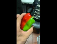 Guy hold half red green bell pepper