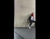 Woman crouches and spins on the wall while she leans