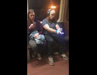 Guy blue shirt headphones white beanie gloving lights subway train