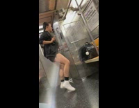 Collab Subway Creatures - Woman black bomber jacket dances with earphones on in empty subway train